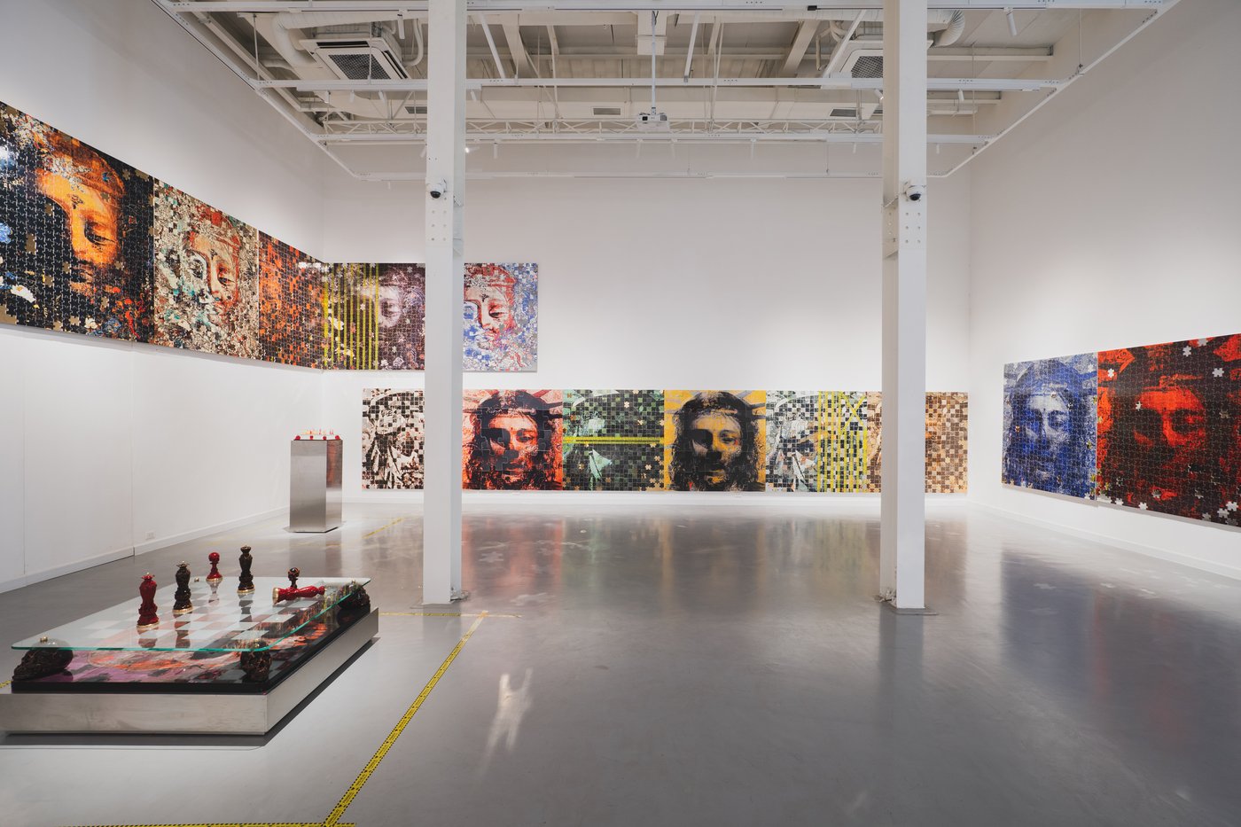 Exhibition view with jigsaw paintings and chess set